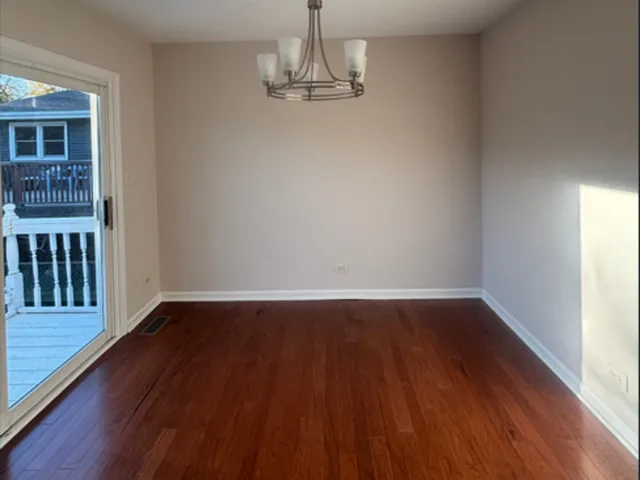 a view of a room with wooden floor and large window