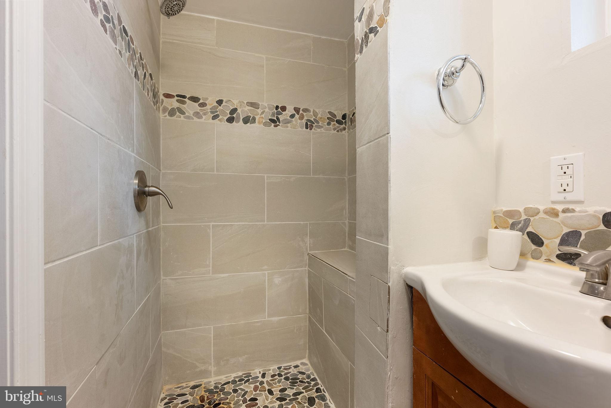 2600 Arcola Avenue Silver Spring, MD 20902 - Photo 23 of 39 a bathroom with a shower sink and mirror
