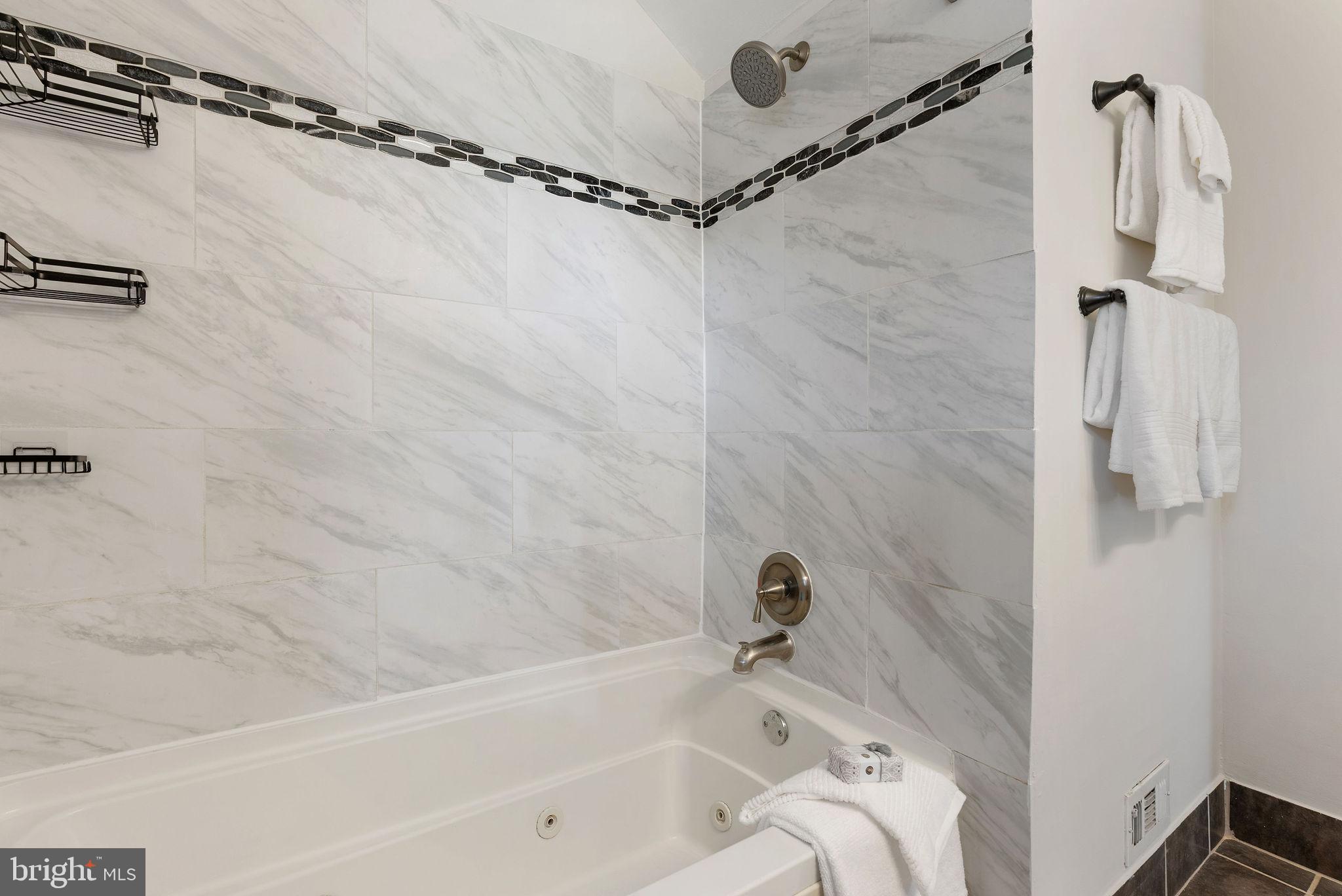 2600 Arcola Avenue Silver Spring, MD 20902 - Photo 26 of 39 a bathroom with a tub shower and a sink