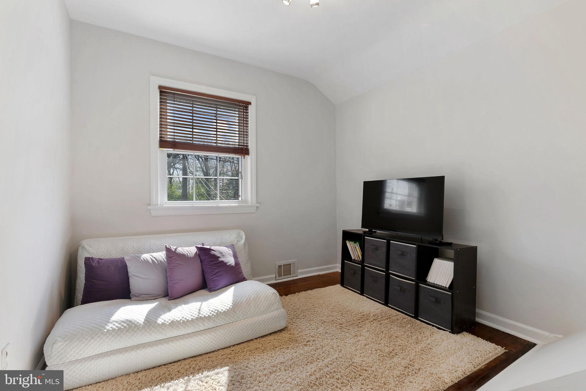 2600 Arcola Avenue Silver Spring, MD 20902 - Photo 32 of 39 a living room with furniture and a flat screen tv