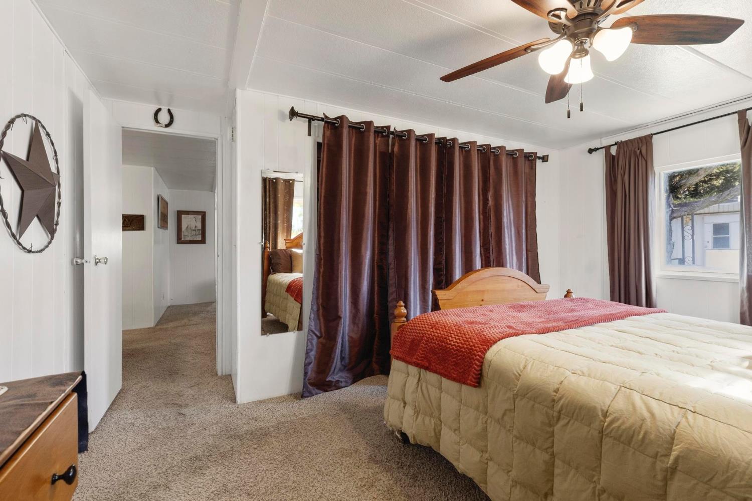 10383 Larkin Road, Unit 15 Live Oak, CA 95953 - Photo 18 of 32 a bedroom with a bed and a chandelier