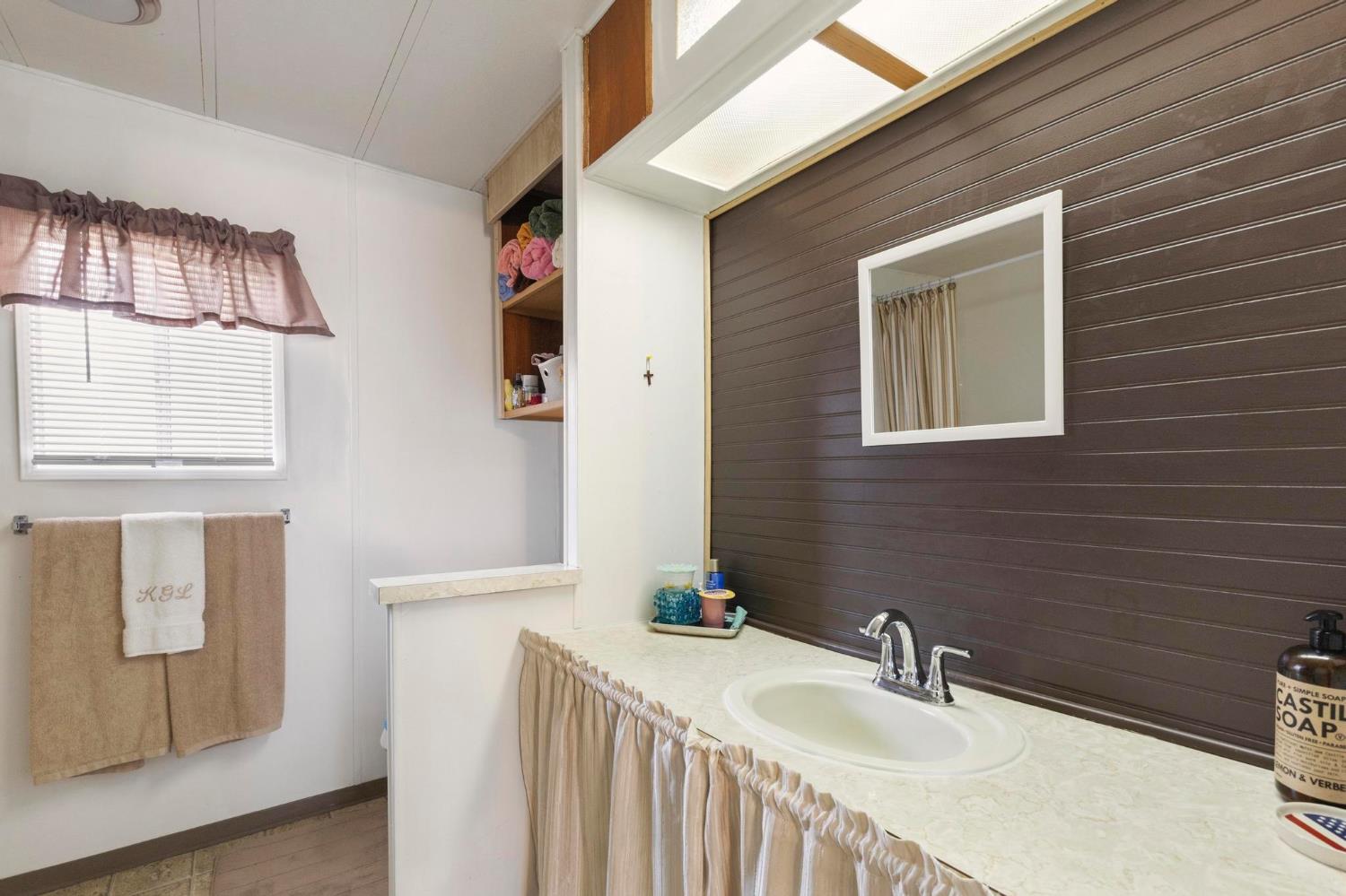 10383 Larkin Road, Unit 15 Live Oak, CA 95953 - Photo 21 of 32 a bathroom with a sink and mirror