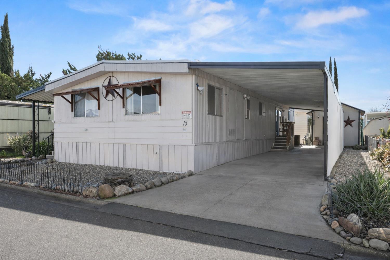10383 Larkin Road, Unit 15 Live Oak, CA 95953 - Photo 27 of 32 a view of a house with a small yard and plants