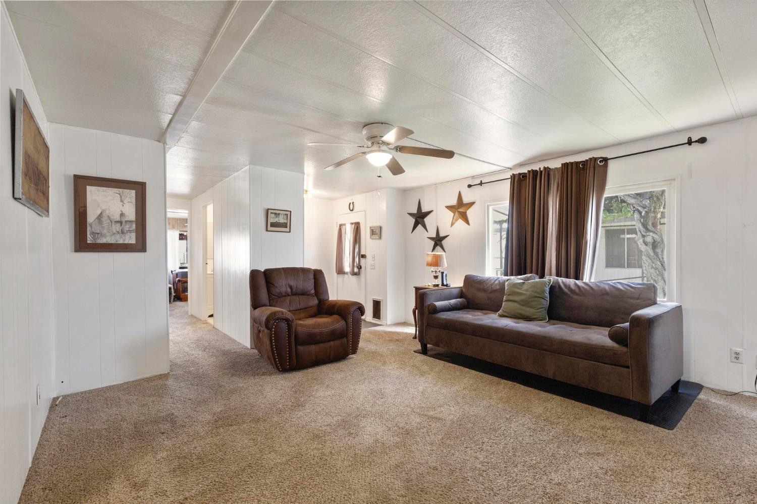 10383 Larkin Road, Unit 15 Live Oak, CA 95953 - Photo 3 of 32 a living room with furniture and a flat screen tv