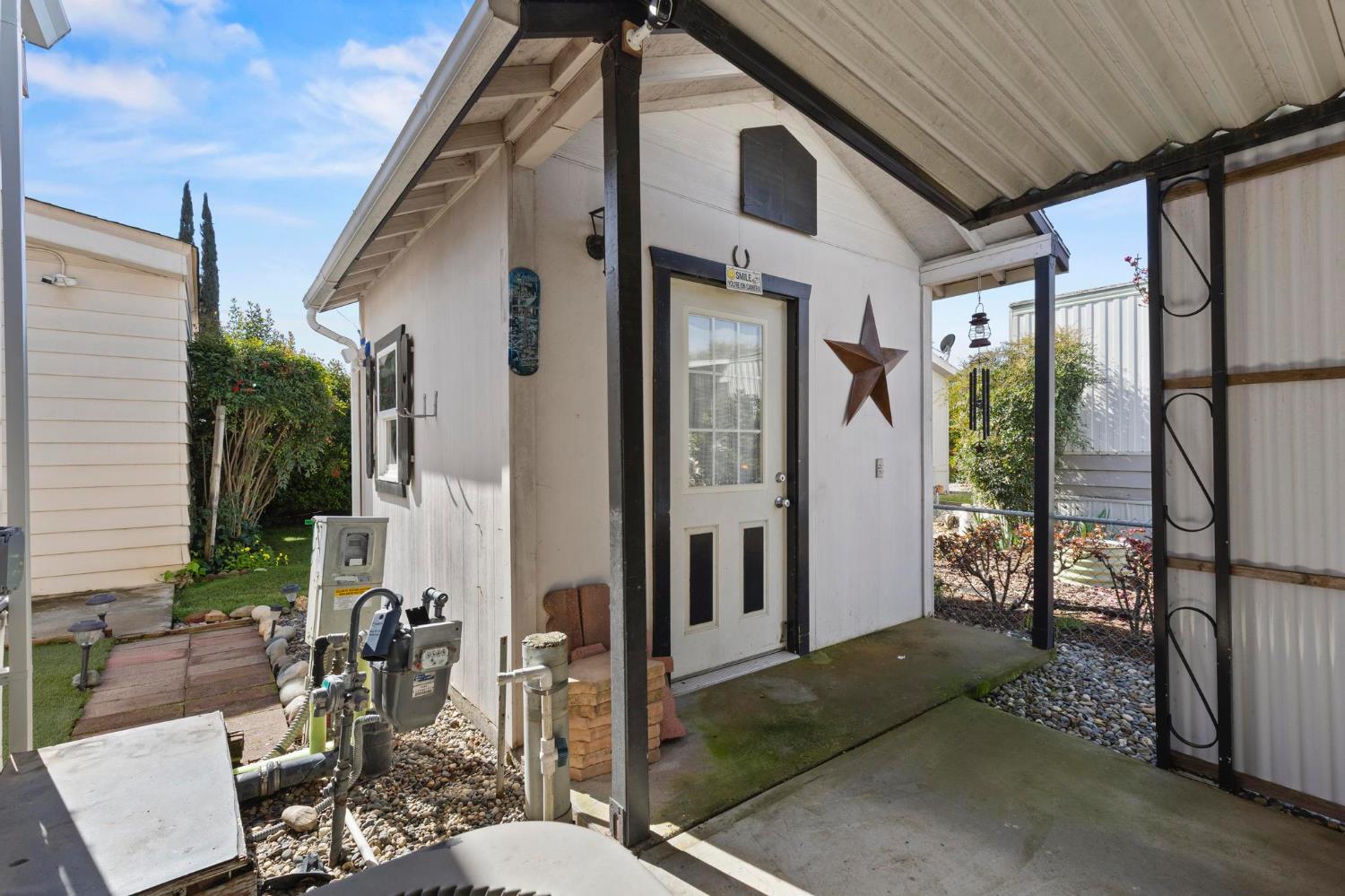 10383 Larkin Road, Unit 15 Live Oak, CA 95953 - Photo 32 of 32 a view of a patio with table and chairs and potted plants