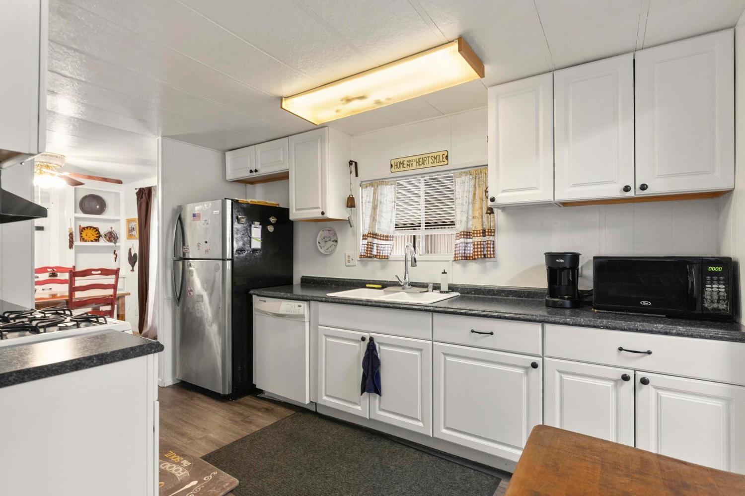 10383 Larkin Road, Unit 15 Live Oak, CA 95953 - Photo 4 of 32 a kitchen with stainless steel appliances granite countertop a refrigerator sink and microwave