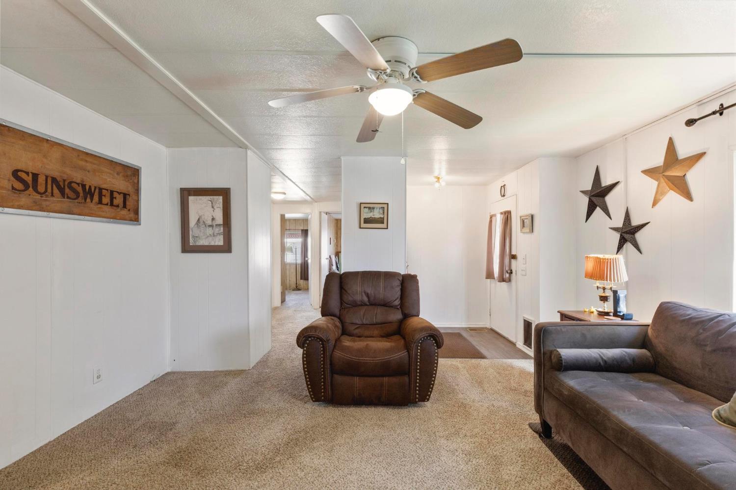 10383 Larkin Road, Unit 15 Live Oak, CA 95953 - Photo 7 of 32 a living room with furniture and a flat screen tv