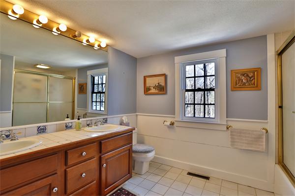 123 East Bare Hill Road Harvard, MA 01451 - Photo 15 of 19 a bathroom with a double vanity sink a toilet and shower