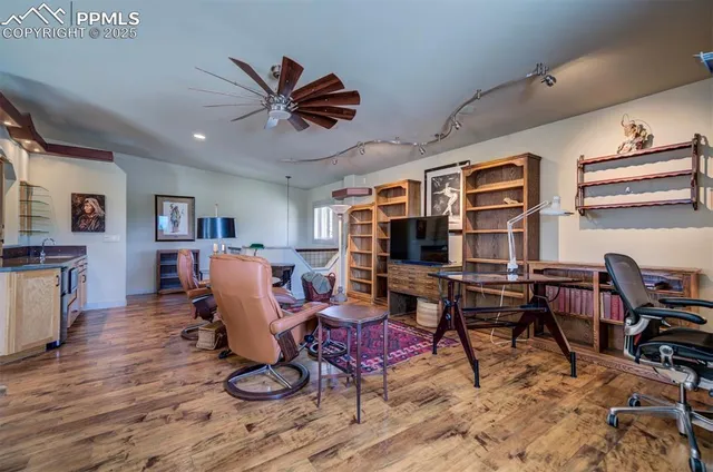 a living room with furniture flat screen tv and wooden floor