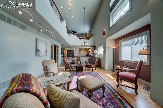 a living room with furniture a rug and a chandelier