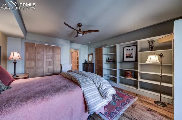 a bedroom with a large bed and a chandelier