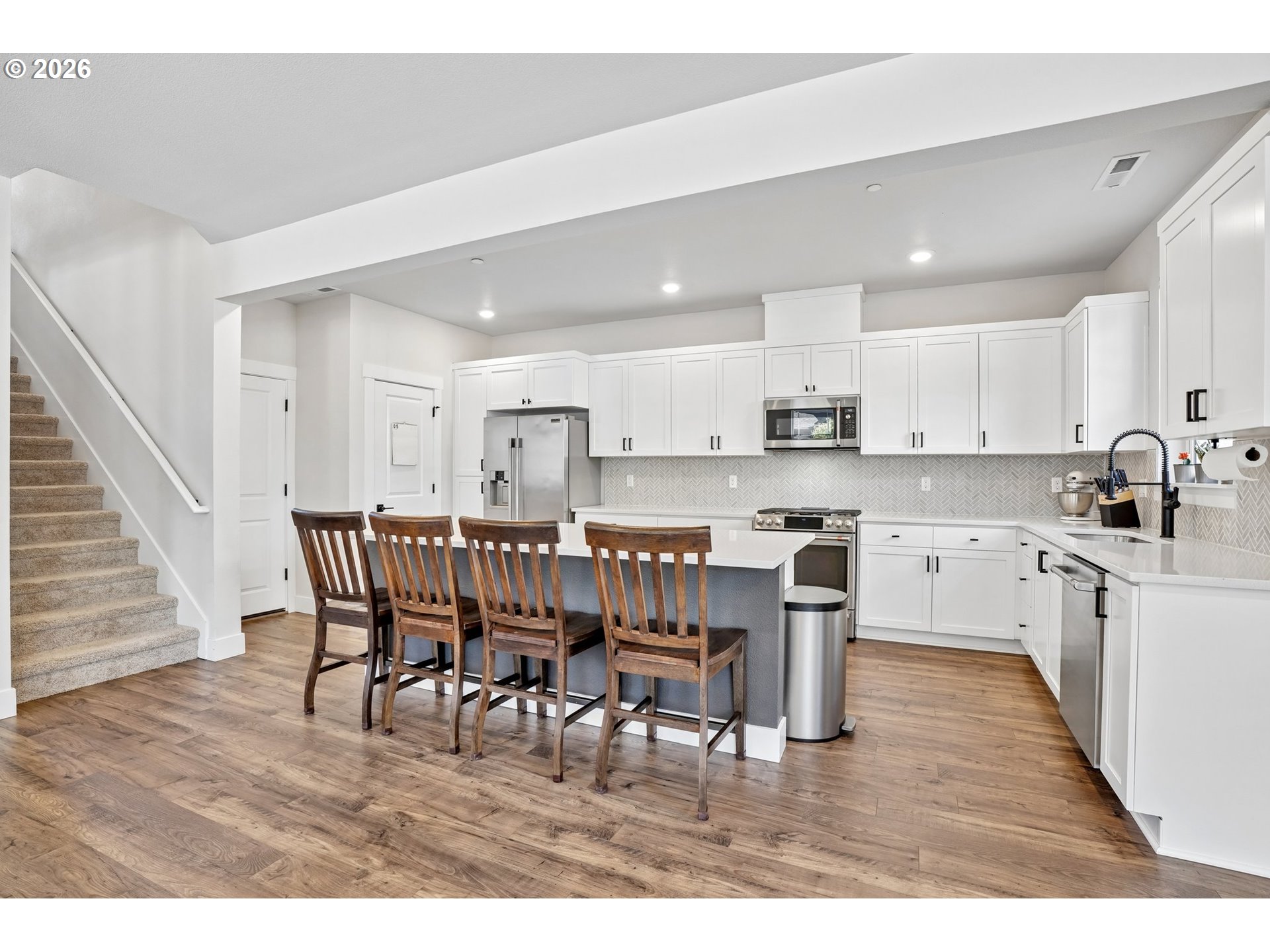 16823 Southwest Colorado Lane Tigard, OR 97224 - Photo 20 of 48 a kitchen with stainless steel appliances granite countertop a table chairs sink refrigerator and cabinets