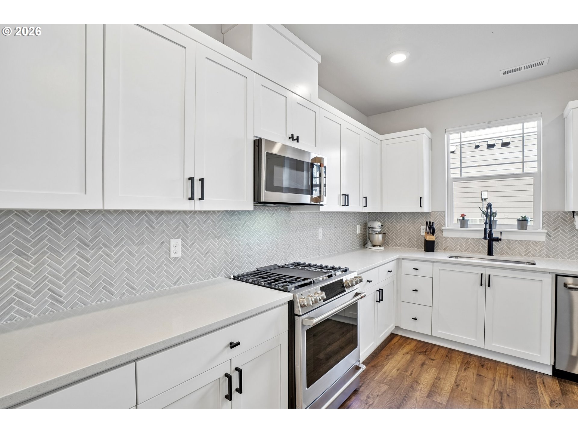 16823 Southwest Colorado Lane Tigard, OR 97224 - Photo 26 of 48 a kitchen with granite countertop white cabinets and white appliances