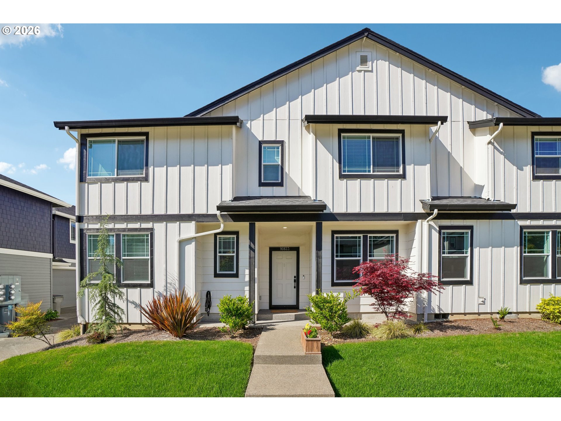 16823 Southwest Colorado Lane Tigard, OR 97224 - Photo 5 of 48 a front view of a house with a yard and potted plants