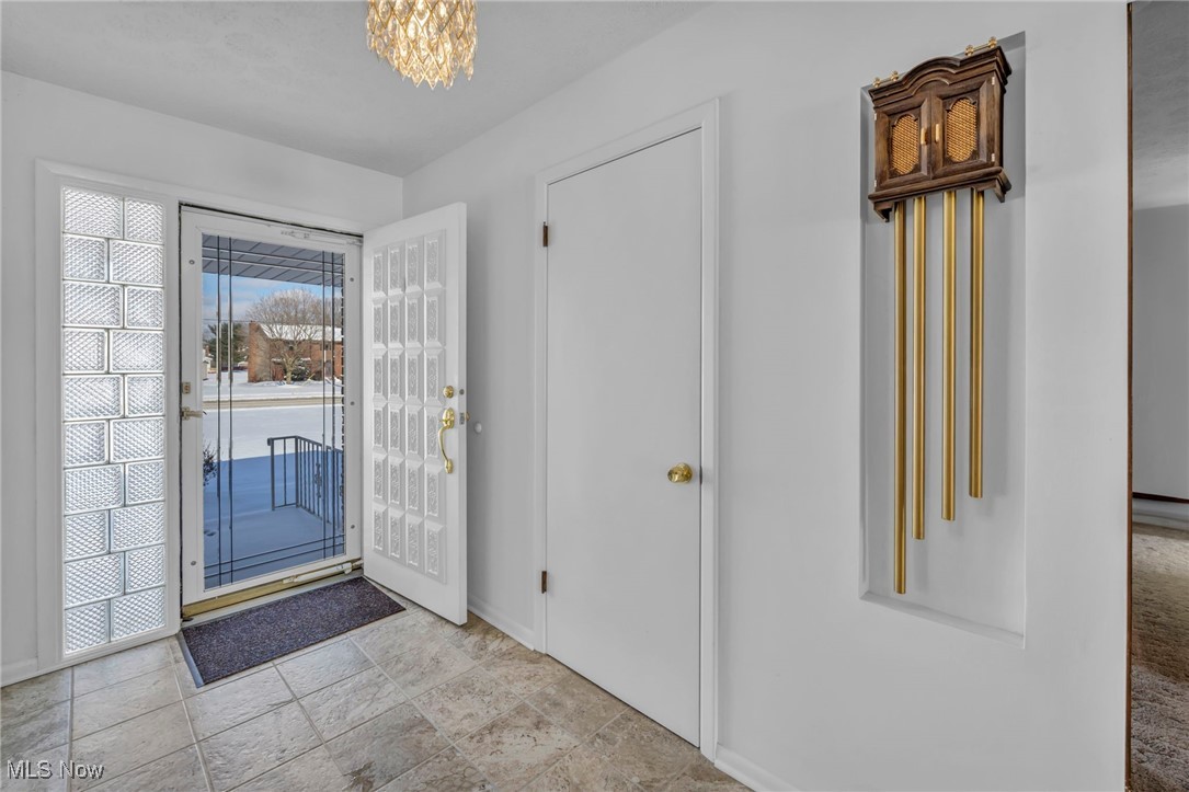 36350 Bainbridge Road Solon, OH 44139 - Photo 3 of 38 Entrance foyer featuring a chandelier