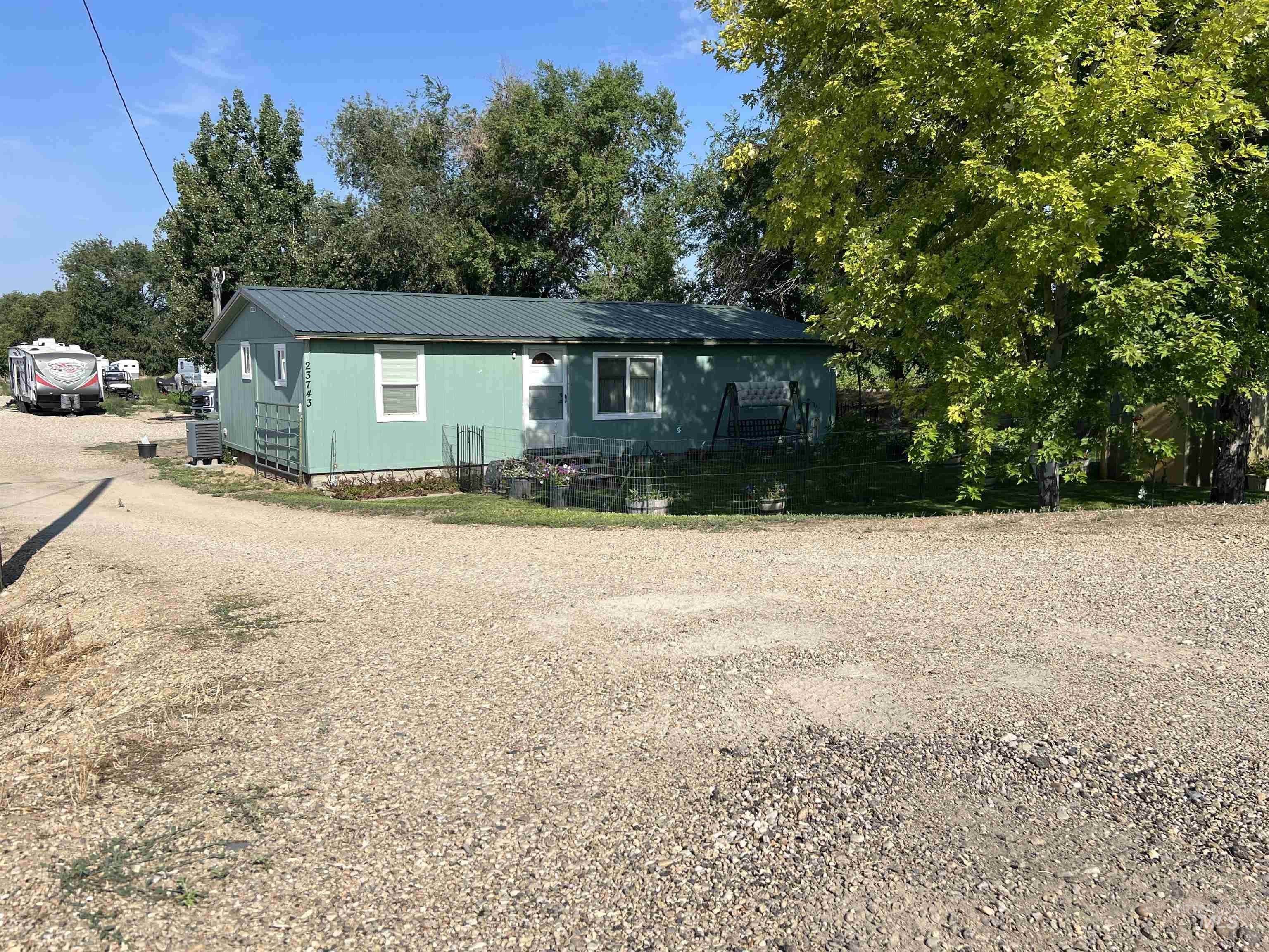 23743 Stephen Lane Parma, ID 83660 - Photo 21 of 34 View of front of property with dirt driveway and a metal roof