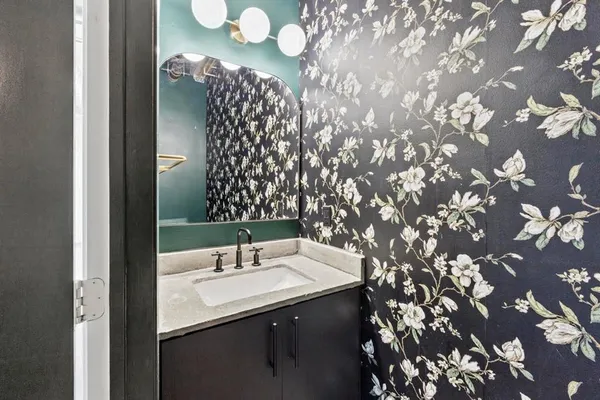 a bathroom with a sink vanity and mirror