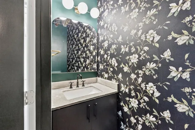 a bathroom with a sink vanity and mirror