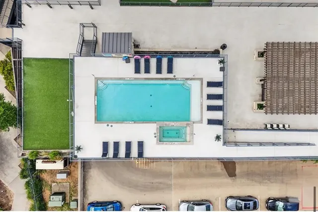 an aerial view of residential houses with outdoor space and parking