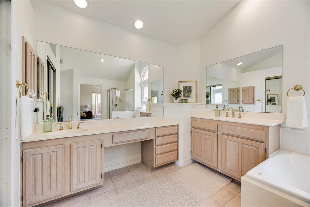 1406 West Peters Colony Road Carrollton, TX 75007 - Photo 11 of 29 a large bathroom with a large mirror vanity and sink