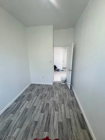 a view of a room with wooden floor and white walls