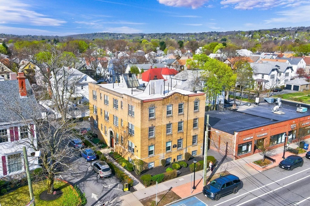 230 Massachusetts Avenue, Unit 2 Arlington, MA 02474 - Photo 19 of 25 an aerial view of multiple houses with a yard