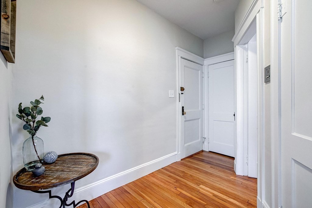 230 Massachusetts Avenue, Unit 2 Arlington, MA 02474 - Photo 3 of 25 a view of a room with wooden floor and table chair