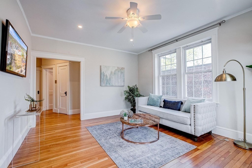 230 Massachusetts Avenue, Unit 2 Arlington, MA 02474 - Photo 7 of 25 a living room with furniture and a table