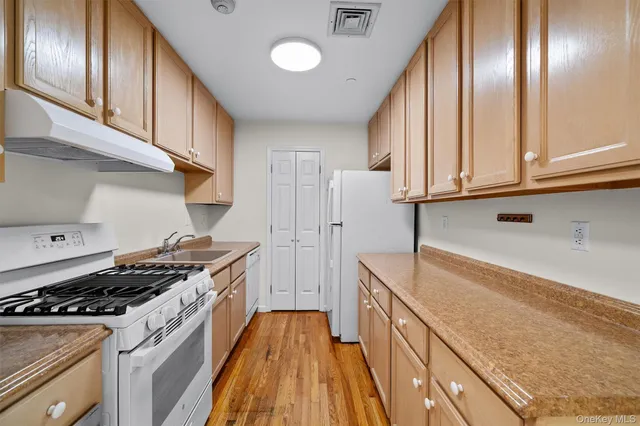 a kitchen with granite countertop stainless steel appliances and wooden cabinets