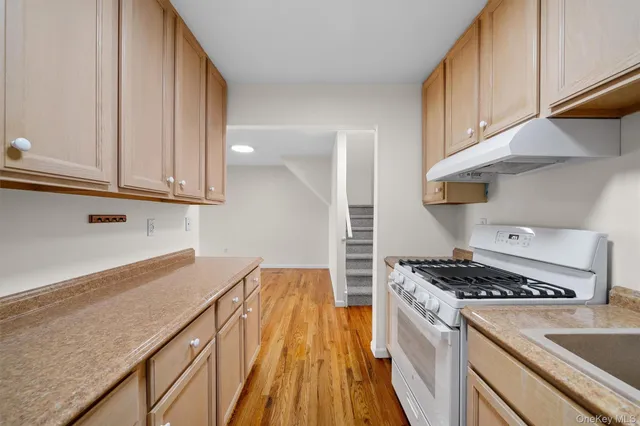 a kitchen with granite countertop a stove and a sink