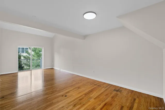 a view of a kitchen with wooden floor and a sink