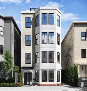 a front view of a building with a garden