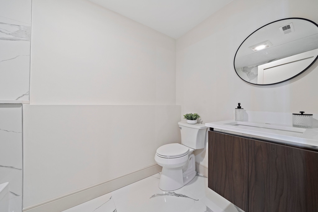 59 Falcon Street, Unit 3 Boston, MA 02128 - Photo 12 of 23 a bathroom with a sink a toilet and a mirror