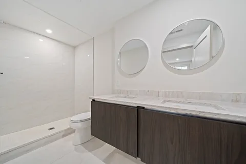 a bathroom with a double vanity sink and a mirror