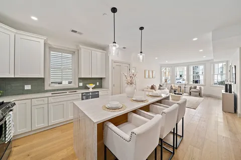 a large kitchen with a table and chairs