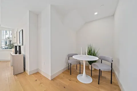 a view of a room with a table and chairs in it