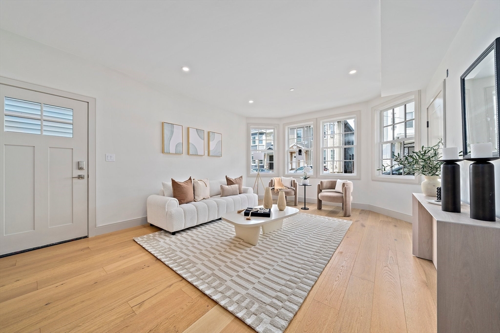 59 Falcon Street, Unit 3 Boston, MA 02128 - Photo 8 of 23 a living room with furniture large window and wooden floor
