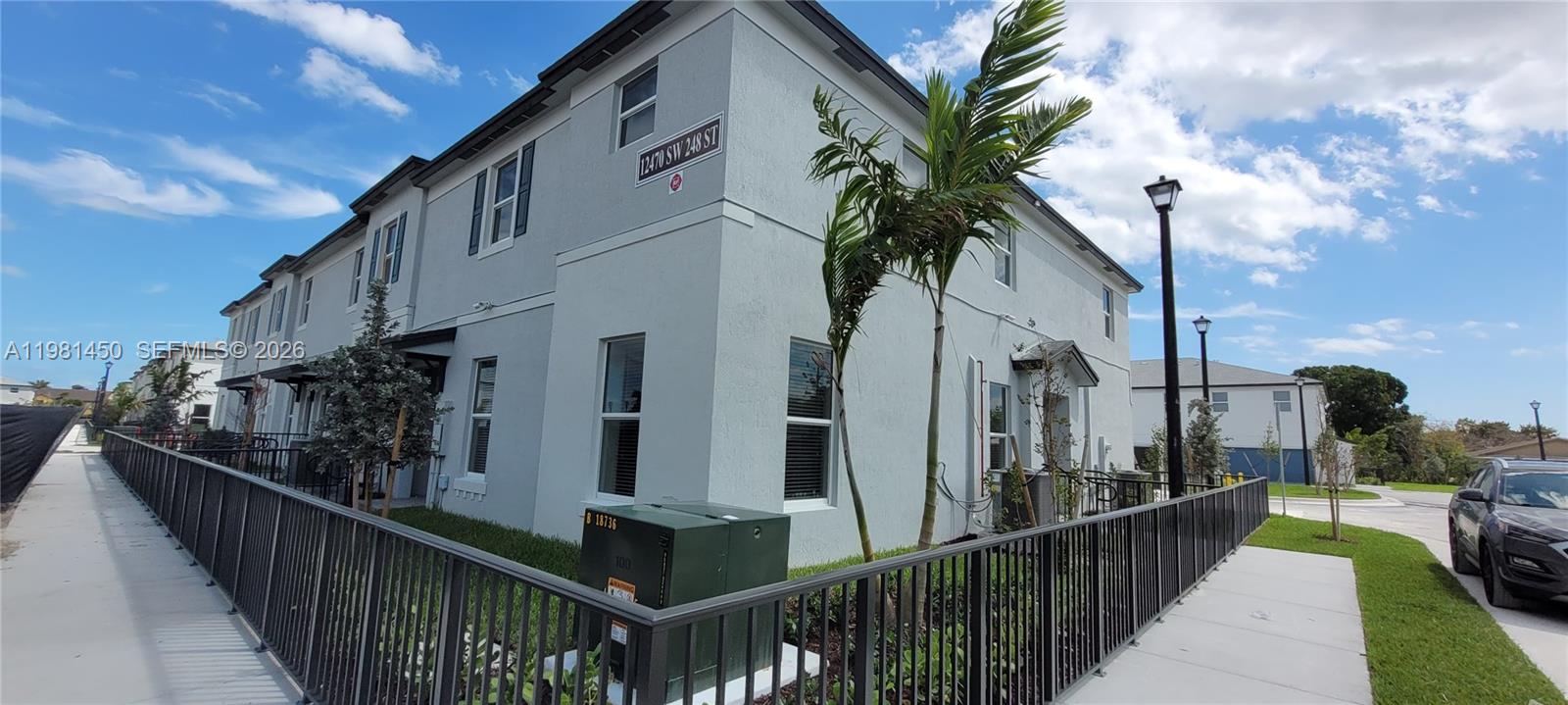 12470 Southwest 248th Street, Unit 5 Homestead, FL 33032 - Photo 1 of 18 a view of a street with a building in the background