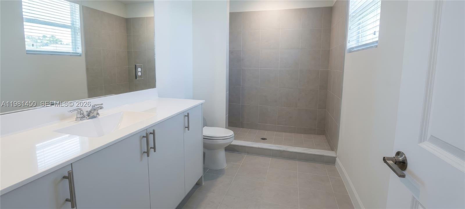 12470 Southwest 248th Street, Unit 5 Homestead, FL 33032 - Photo 12 of 18 a bathroom with a sink a toilet and shower
