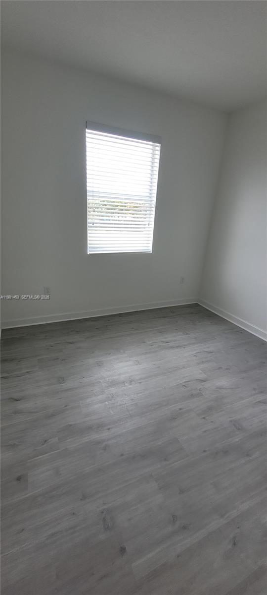 12470 Southwest 248th Street, Unit 5 Homestead, FL 33032 - Photo 13 of 18 an empty room with a window