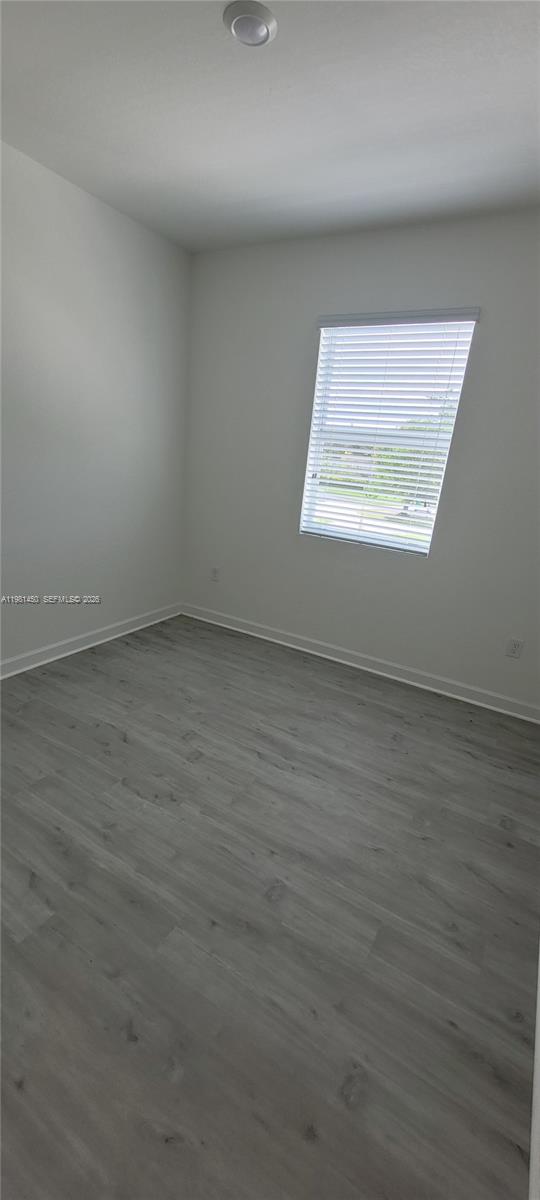 12470 Southwest 248th Street, Unit 5 Homestead, FL 33032 - Photo 14 of 18 an empty room with a window
