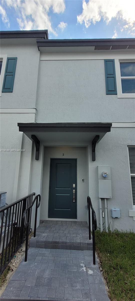 12470 Southwest 248th Street, Unit 5 Homestead, FL 33032 - Photo 16 of 18 a front view of a house with parking space