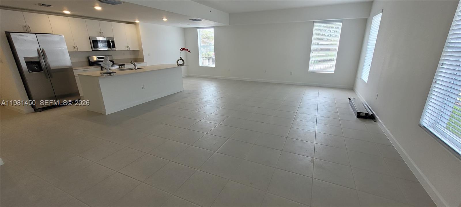 12470 Southwest 248th Street, Unit 5 Homestead, FL 33032 - Photo 2 of 18 a kitchen with stainless steel appliances a refrigerator and a counter top space
