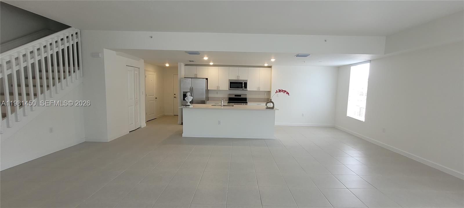 12470 Southwest 248th Street, Unit 5 Homestead, FL 33032 - Photo 5 of 18 a view of a kitchen with a sink cabinets and a living room