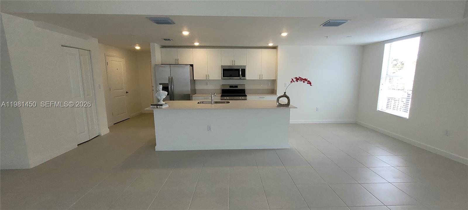 12470 Southwest 248th Street, Unit 5 Homestead, FL 33032 - Photo 6 of 18 a view of kitchen with kitchen island stainless steel appliances a refrigerator and a stove top oven
