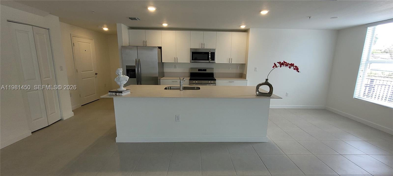 12470 Southwest 248th Street, Unit 5 Homestead, FL 33032 - Photo 7 of 18 a view of living room with furniture and a flat screen tv