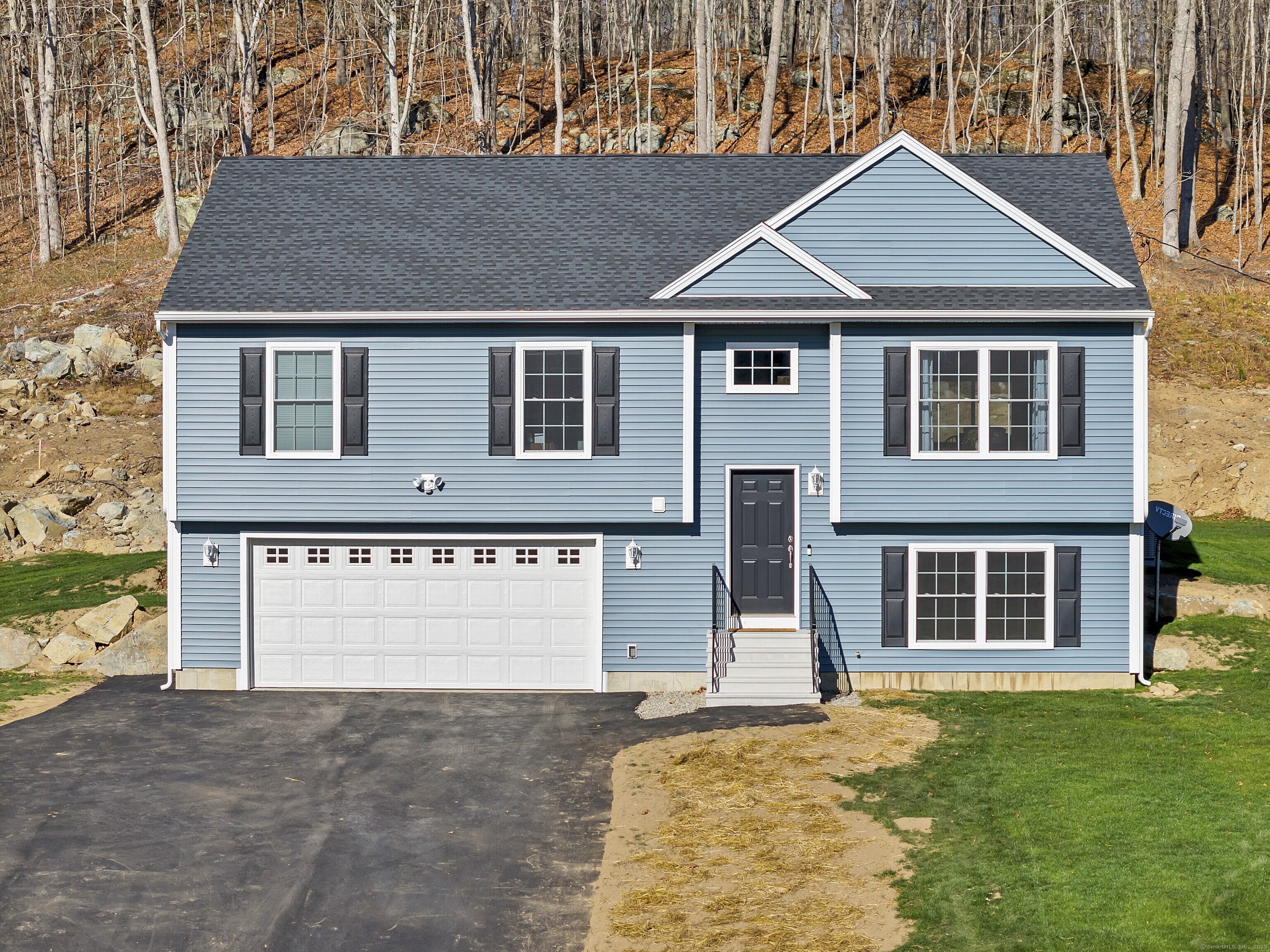 4 Lake Of Isles Road North Stonington, CT 06359 - Photo 1 of 23 a front view of a house with a yard and garage