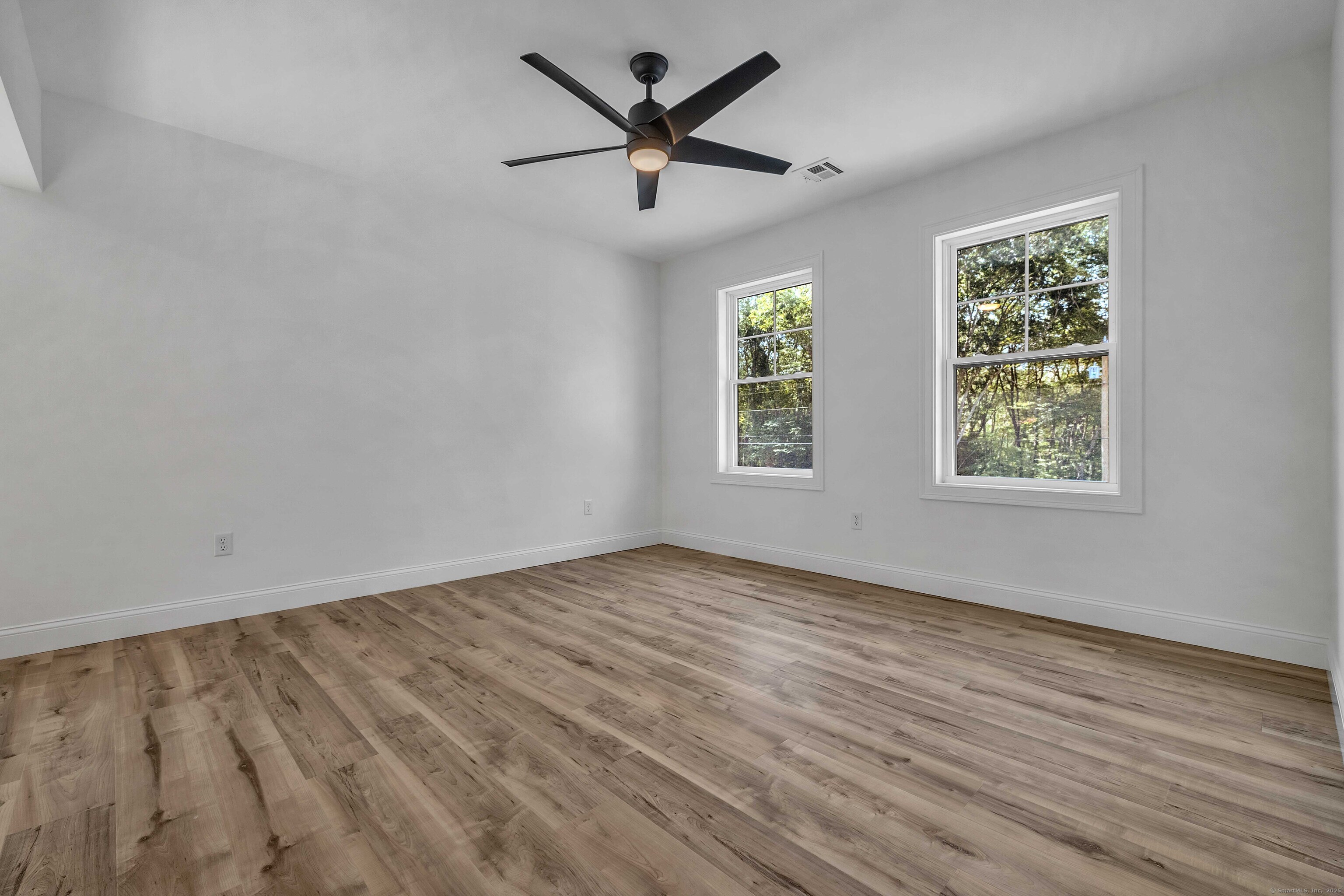 4 Lake Of Isles Road North Stonington, CT 06359 - Photo 19 of 23 wooden floor in an empty room with a window
