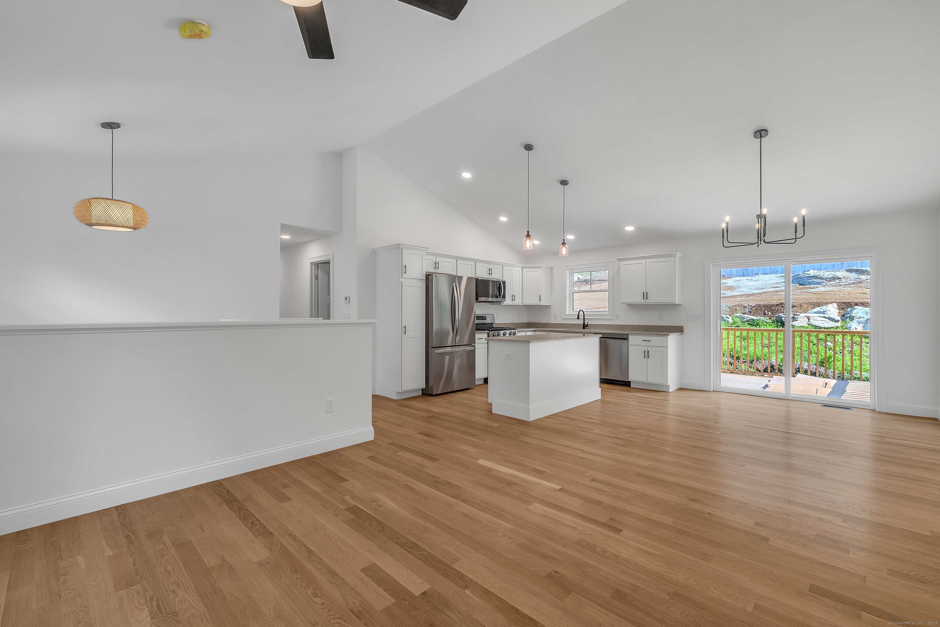 4 Lake Of Isles Road North Stonington, CT 06359 - Photo 8 of 23 a view of a kitchen with a stove cabinets and wooden floor