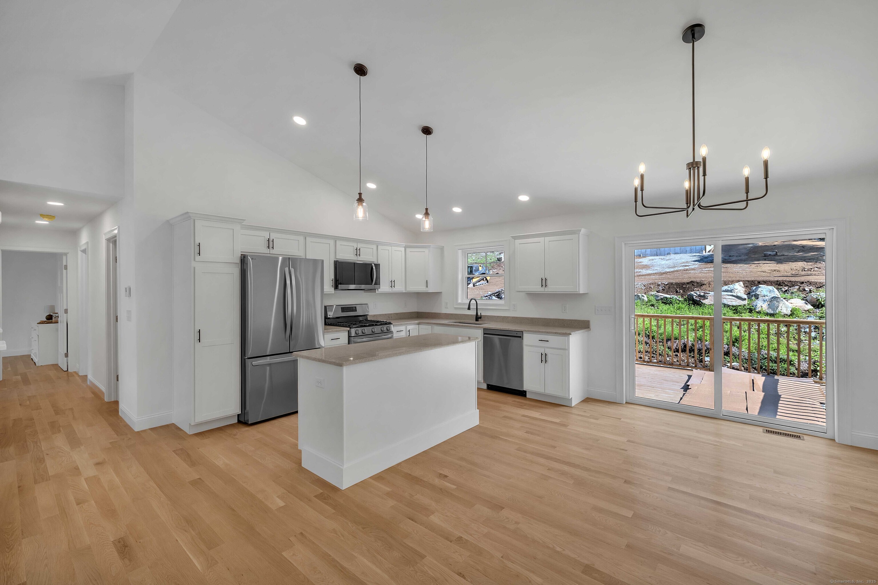 4 Lake Of Isles Road North Stonington, CT 06359 - Photo 9 of 23 a open kitchen with stainless steel appliances granite countertop a refrigerator a sink a stove and a wooden floors